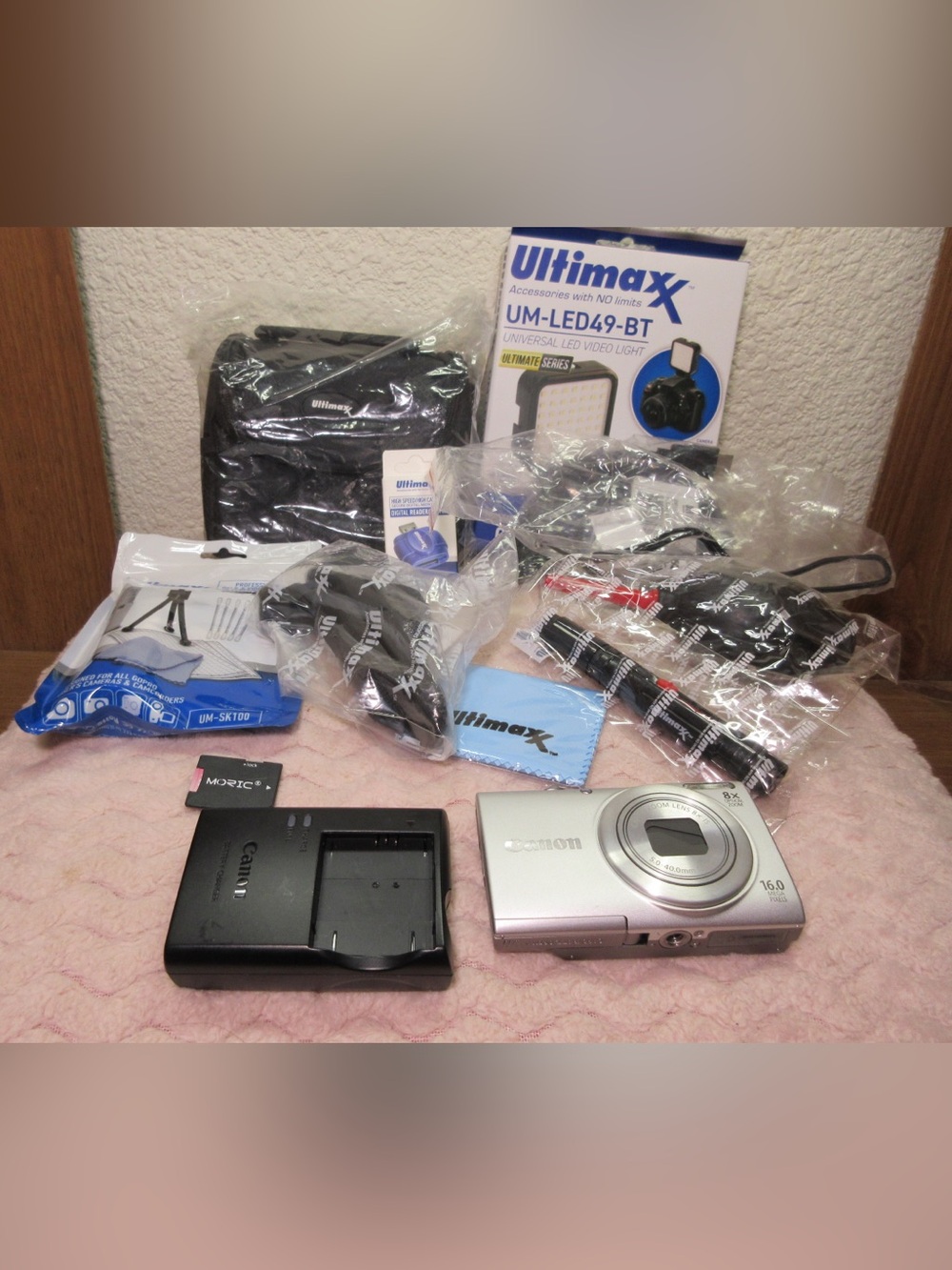 Canon Silver Compact Camera with Black Charger and Accessories
